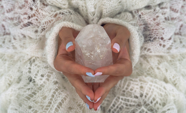 hand holding a crystal clear quartz