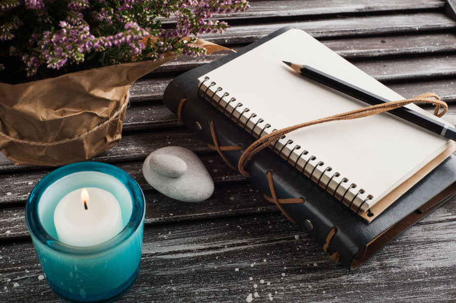 journal with pen and candle