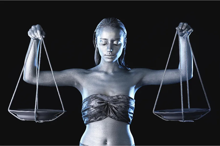 Woman balancing scales for libra zodiac sign