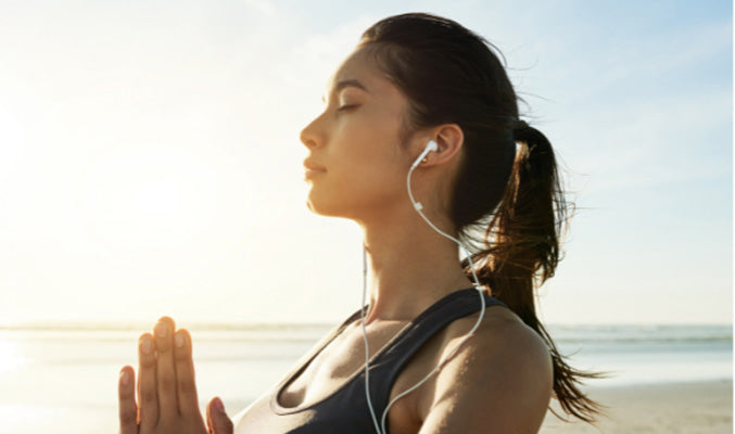 woman meditating and listening to music