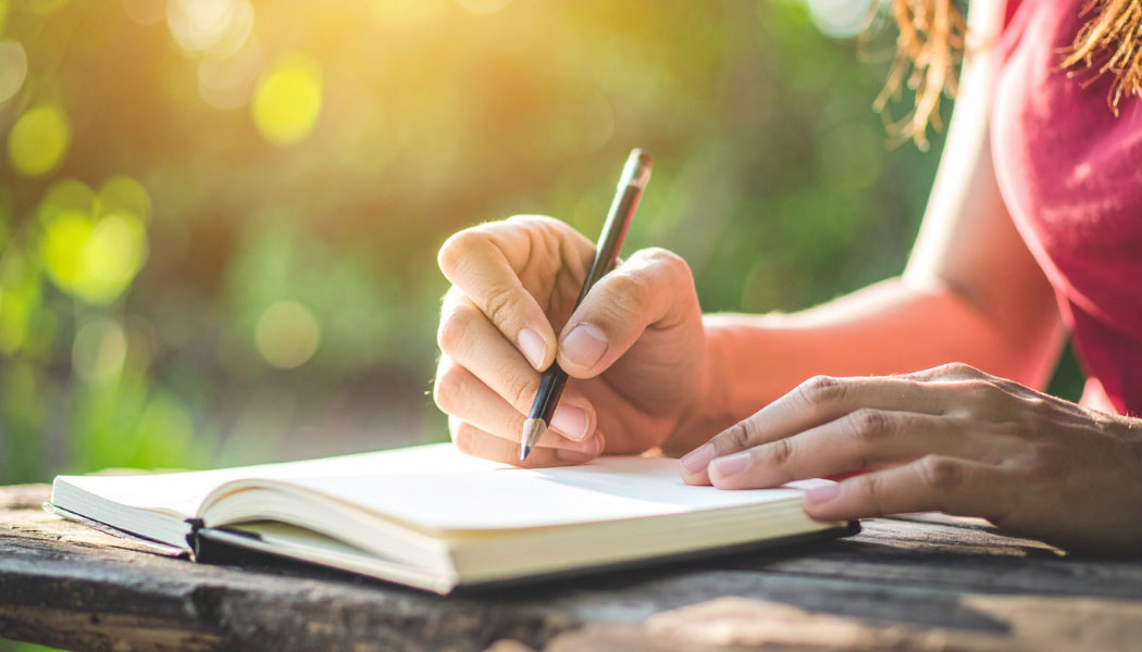 woman writing in journal 