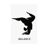 A minimalist black graphic of a person in a handstand pose on a white rectangular panel, with the word 'BALANCE' printed below in black sans-serif text.