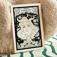 Celebrate Capricorn with an ornate cosmic portrait featuring the Capricorn constellation, zodiac symbol, Saturn, Earth element, and celestial details.