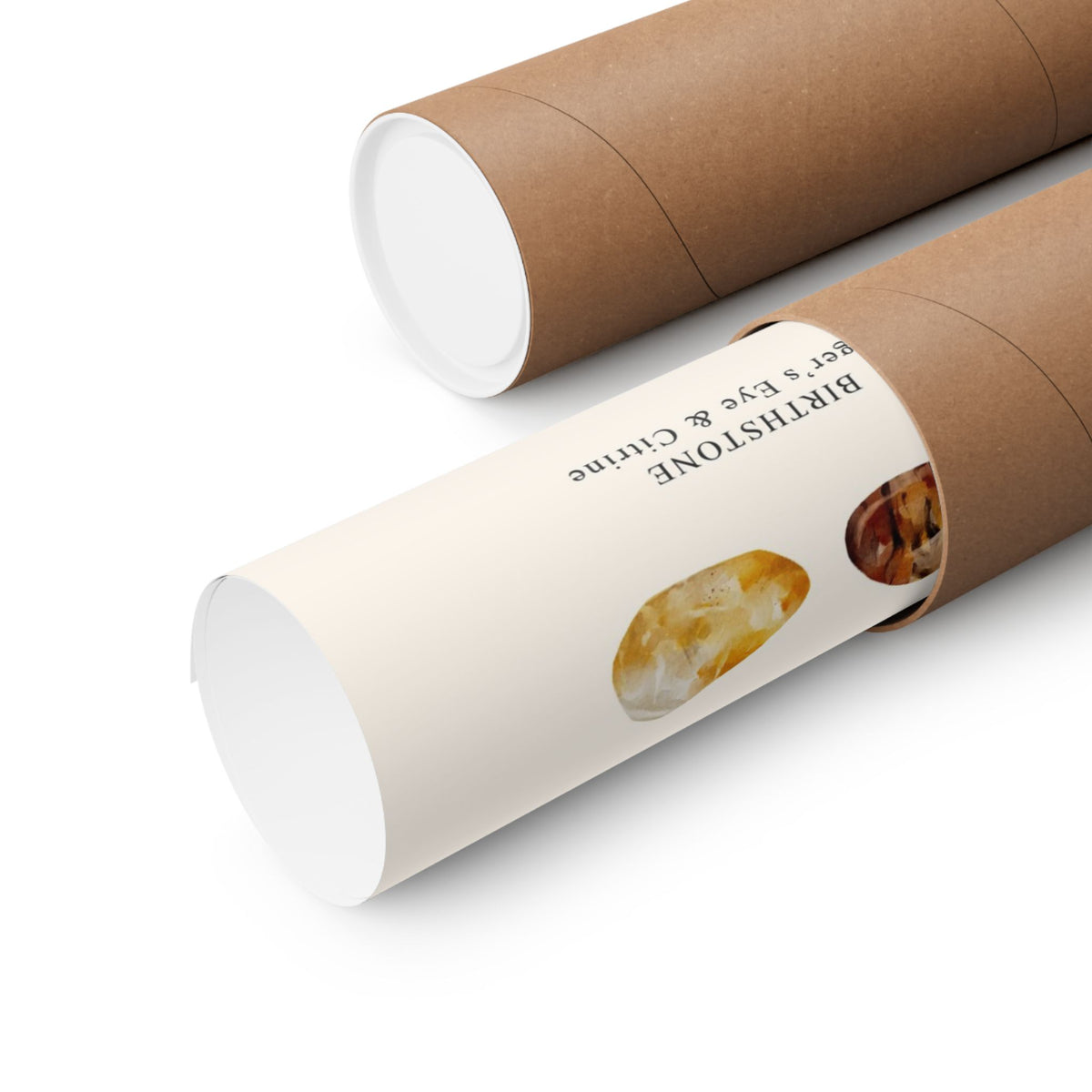 Two brown kraft paper cylindrical gift tubes on a white background, one showing a cream label with black text reading 'BIRTHSTONE gem & eye & crystal' and a crystal photo.