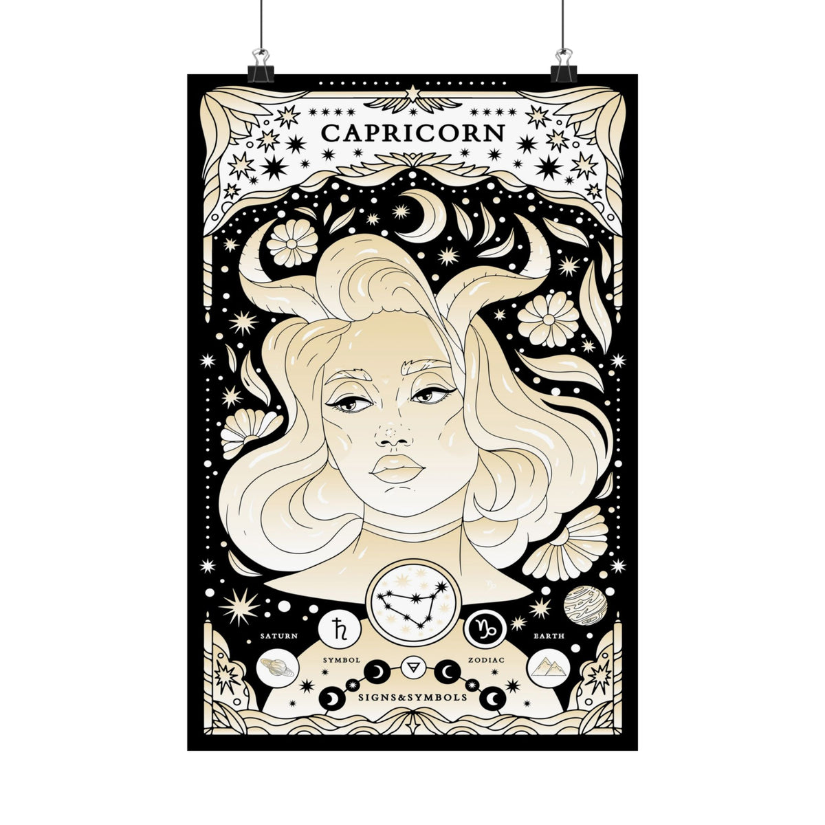 A vertical Capricorn zodiac poster with an ornate black, cream, and beige illustration of a woman's face surrounded by stars, crescent moons, flowers, and astrological symbols. The word 'CAPRICORN' appears at the top, and the poster is shown hanging against a white background with two black clips at the top.