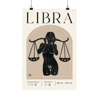 A minimalist Libra zodiac poster featuring a black silhouette of a woman holding the scales of justice, with the word 'LIBRA' in large serif letters at the top and additional astrological details at the bottom, shown hanging against a white background.