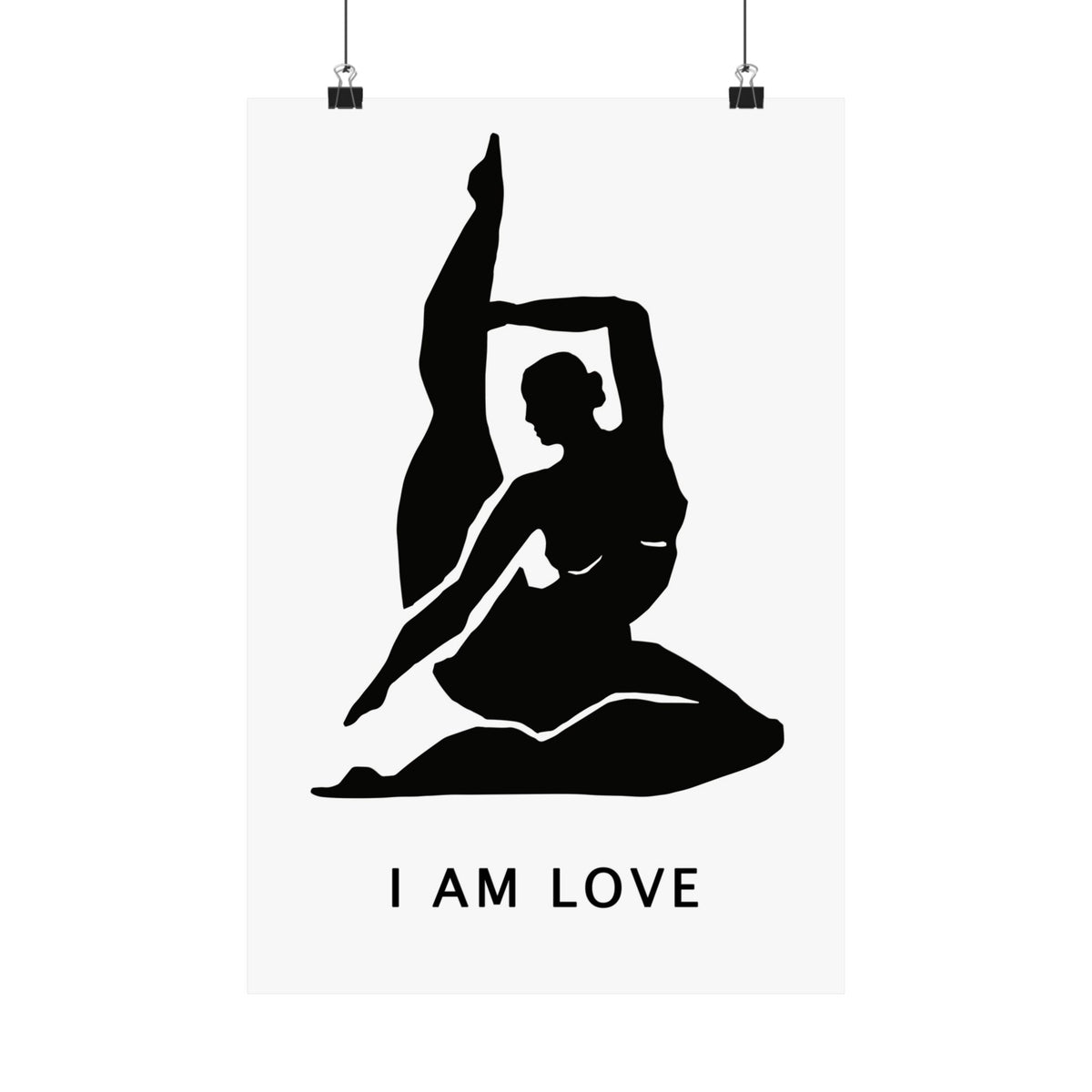 A minimalist black and white art print featuring a silhouette of a woman in a yoga pose with the text 'I AM LOVE' underneath, shown hanging from two black clips against a white background.