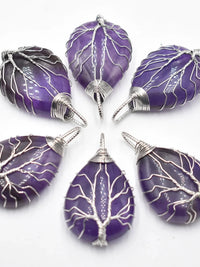 Purple amethyst teardrop pendants wrapped in silver wire tree design