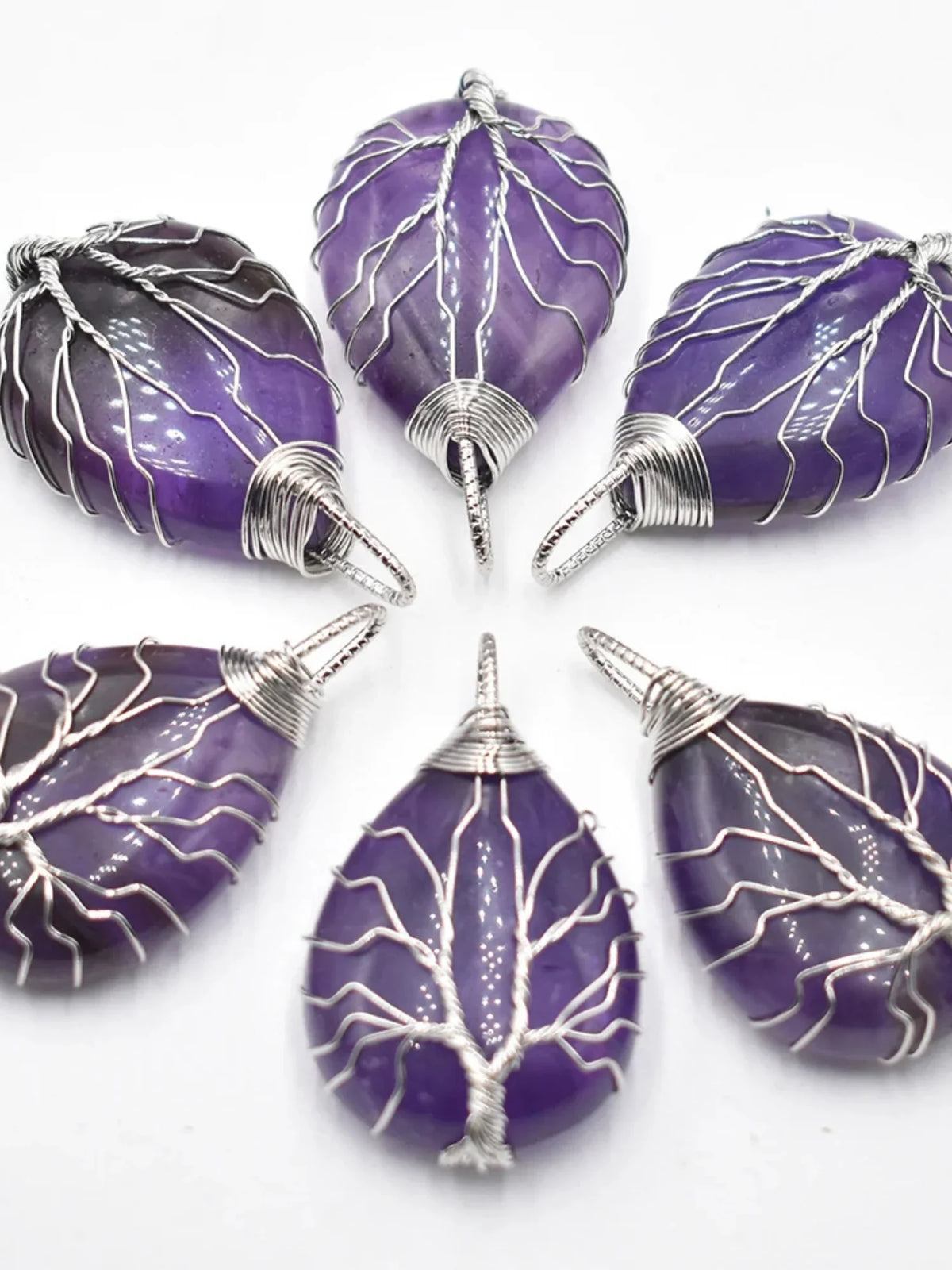 Purple amethyst teardrop pendants wrapped in silver wire tree design