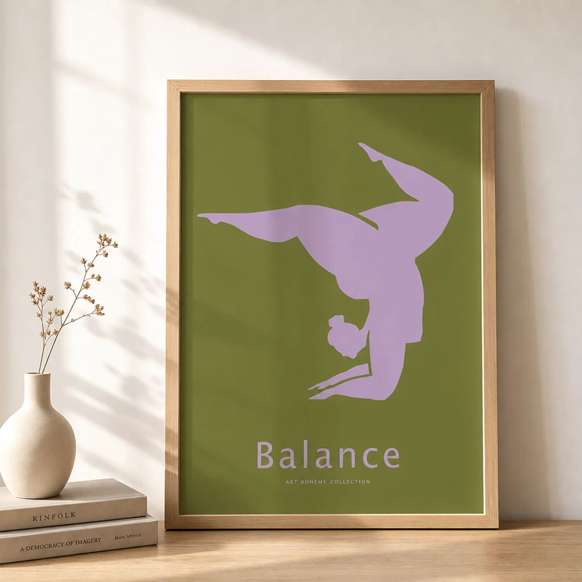 Minimalist yoga art print featuring a lavender yoga silhouette on an olive-green background, displayed in a black frame.