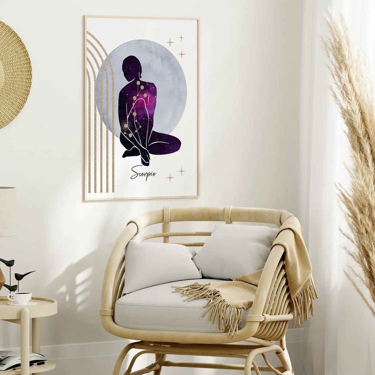 A framed wall art print featuring a seated figure silhouette filled with purple and black starry patterns against a pale blue-gray circle, styled above a rattan armchair in a bright neutral room.