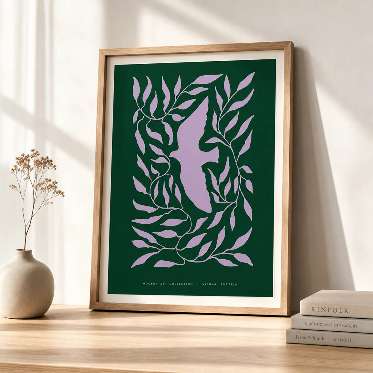 Modern dove botanical art print featuring a lavender dove surrounded by flowing leaves on a deep forest-green background, displayed in a brown frame