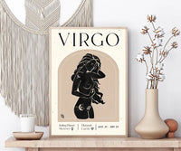 A framed Virgo astrology art print displayed on a wooden shelf in a styled home decor setting, featuring a beige macrame wall hanging, a candle, and a vase with dried flowers.