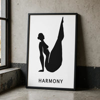 A minimalist black and white art print featuring a silhouette of a woman in a yoga pose with the word 'HARMONY' black frame