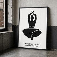 A minimalist black-and-white wall art print featuring a seated yoga figure with the text 'INHALE THE FUTURE EXHALE THE PAST'  black frame