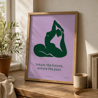 Framed minimalist yoga art print featuring a deep-green yoga silhouette and the words “Inhale the future, exhale the past” on a lavender background.
