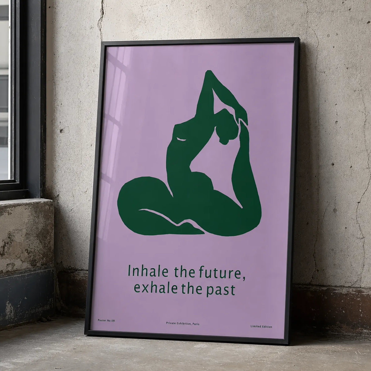 Framed minimalist yoga art print featuring a deep-green yoga silhouette and the words “Inhale the future, exhale the past” on a lavender background. w black frame