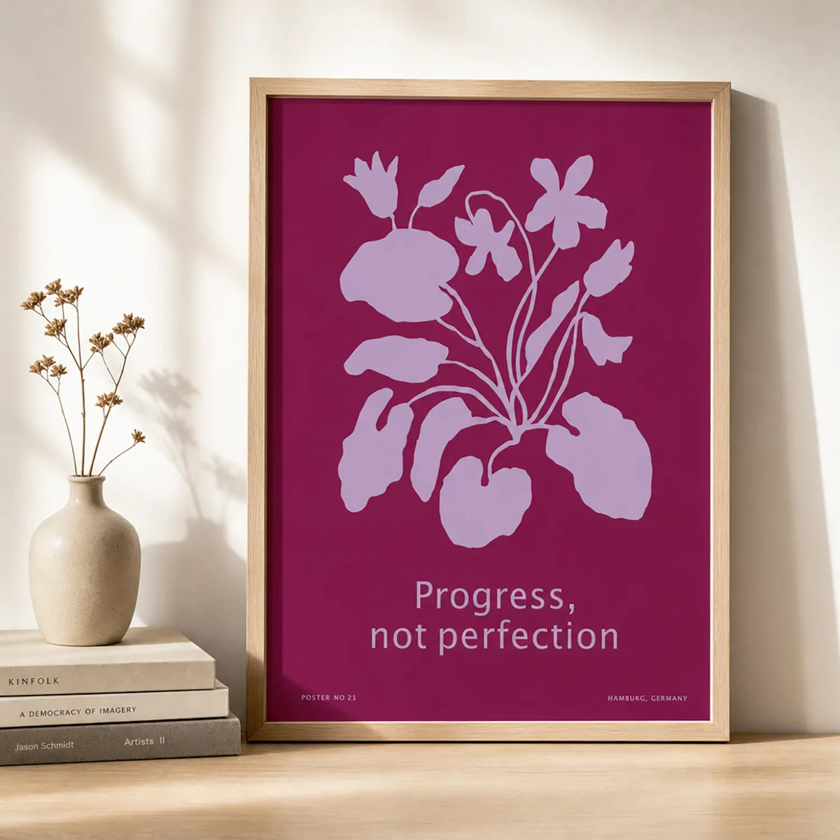 Framed botanical art print featuring lavender flowers on a rich berry-pink background with the words “Progress, not perfection.”