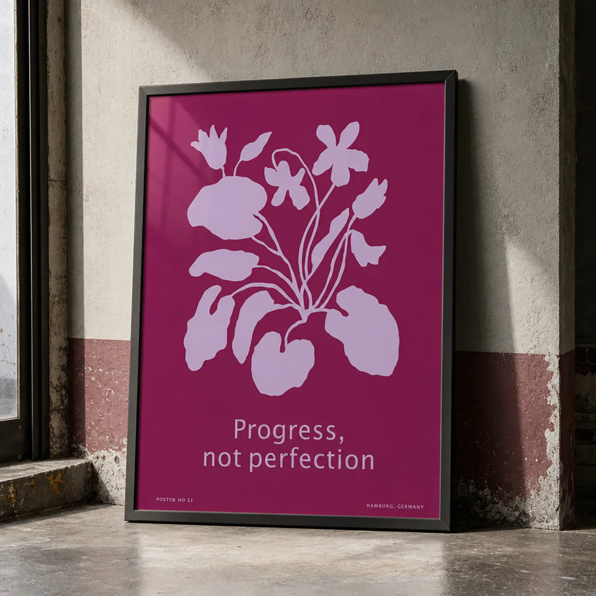 Framed botanical art print featuring lavender flowers on a rich berry-pink background with the words “Progress, not perfection.” w black frame