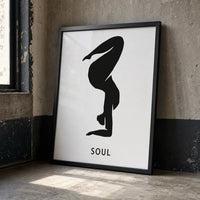 A minimalist black graphic of a person in a yoga or handstand pose on a white rectangular card, with the word 'SOUL' in black frame