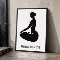 A minimalist black graphic print featuring a silhouette of a person in a seated meditation pose on a white background, with the word 'MINDFULNESS'  in black frame